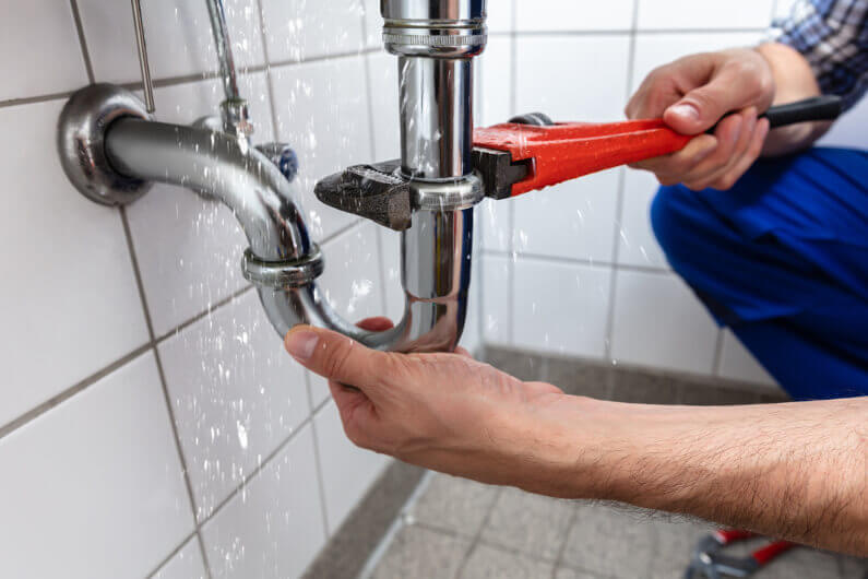 Professional plumber with wrench